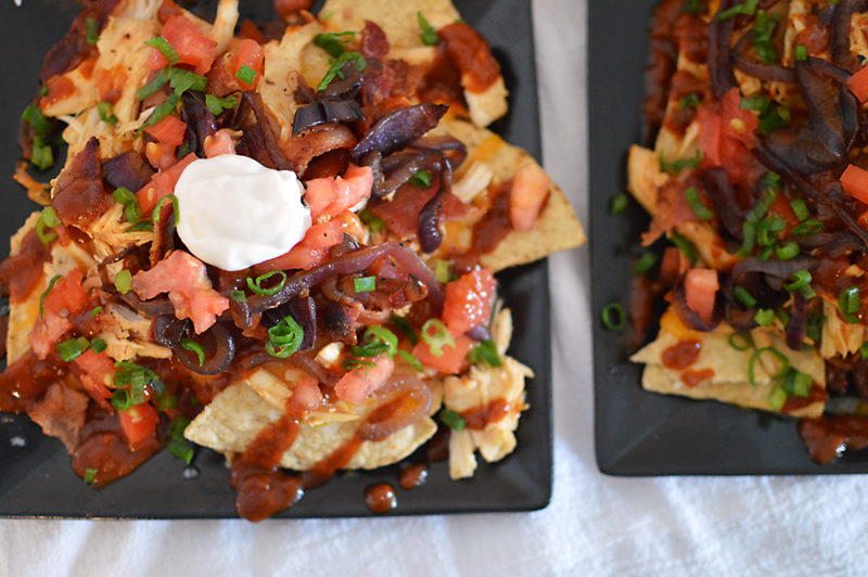 The homemade root beer barbecue sauce is what MAKES this dish! Warm BBQ chicken, cheese, caramelized onions and bacon top these sweet, semi-spicy nachos. Garnish with tomatoes, green onions, and sour cream if you want to max out the flavor! Recipe from thatquareplate.com 