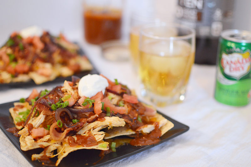 The homemade root beer barbecue sauce is what MAKES this dish! Warm BBQ chicken, cheese, caramelized onions and bacon top these sweet, semi-spicy nachos. Garnish with tomatoes, green onions, and sour cream if you want to max out the flavor! Recipe from thatquareplate.com