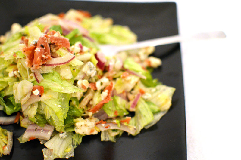 This salad combines salty prosciutto, gorgonzola cheese, red onion, chopped lettuce and homemade Italian dressing. It's everything that makes you happy!