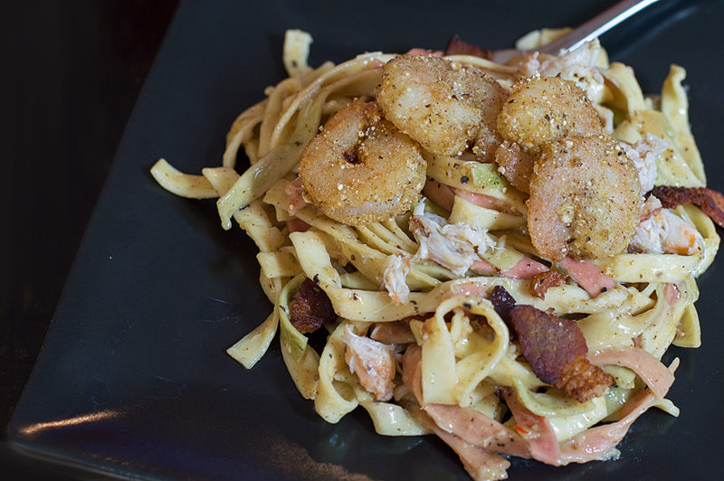 When you can't decide on which meat to cook with, why not add all three!? Shrimp, crab, and bacon with a wine sauce over pasta is never a bad thing.