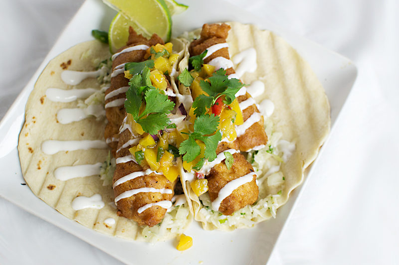 There's something about fish tacos... especially when they're made with fresh mahi and deep fried with a light beer batter, topped with a peach salsa and finished with lime crema!