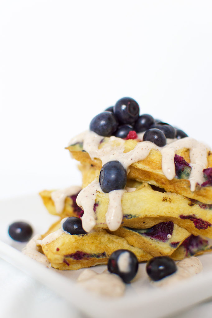 Who wouldn't want to wake up to these fluffy blueberry waffles?! Drizzle the frosting when they're still super-hot, and enjoy with more fresh blueberries.