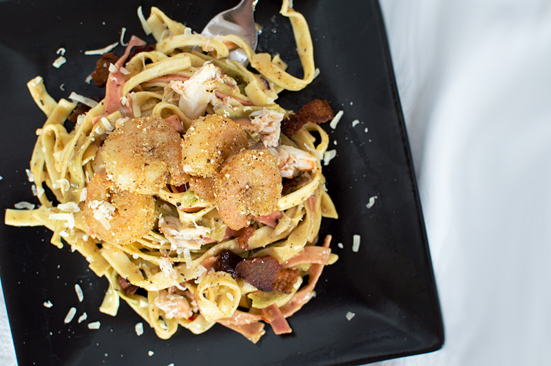 When you can't decide on which meat to cook with, why not add all three!? Shrimp, crab, and bacon with a wine sauce over pasta is never a bad thing.