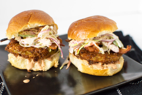 Panko-fried green tomato slices on a slider bun with a spicy Cajun sauce, crispy bacon and a tangy slaw.